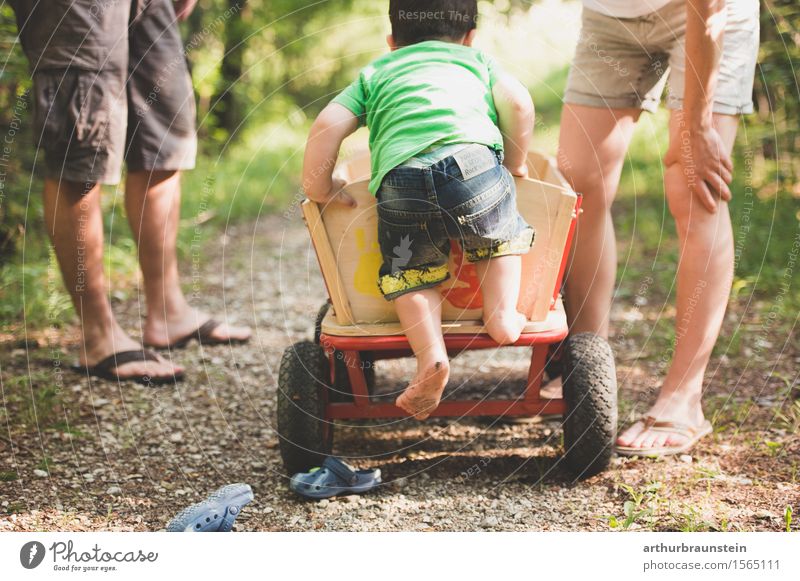 Boy climbs barefoot on ladder truck in nature Leisure and hobbies To go for a walk Trip Summer Parenting Human being Masculine Feminine Child Boy (child)