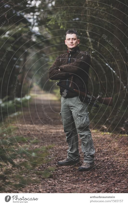 Young hunter with rifle stands in the forest Leisure and hobbies Hunting Hiking Promenade Hunter Human being Masculine Young man Youth (Young adults) Adults