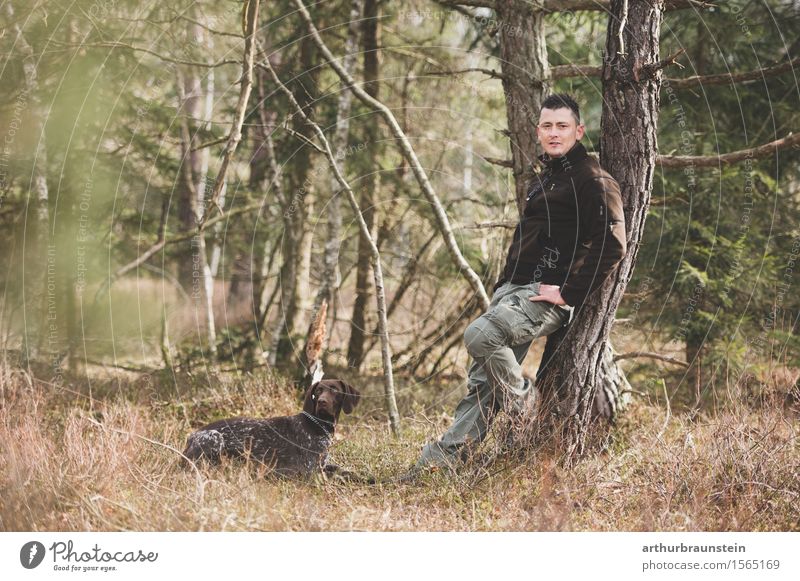 Young man with dog in the forest Leisure and hobbies Hunting Trip Hiking To go for a walk Forester Hunter Human being Masculine Youth (Young adults) Adults Life
