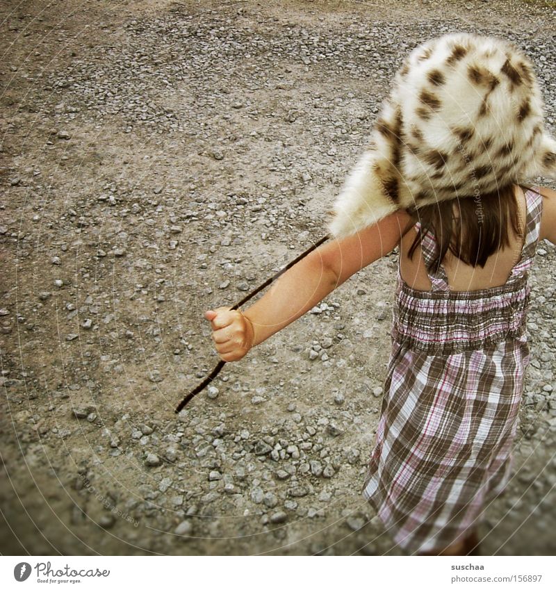 child on gravel with fur cap ... what else ... Child Girl Dress Summer Warmth Winter Gravel Playing Joy Style Strange Whimsical Freedom Infancy Parenting