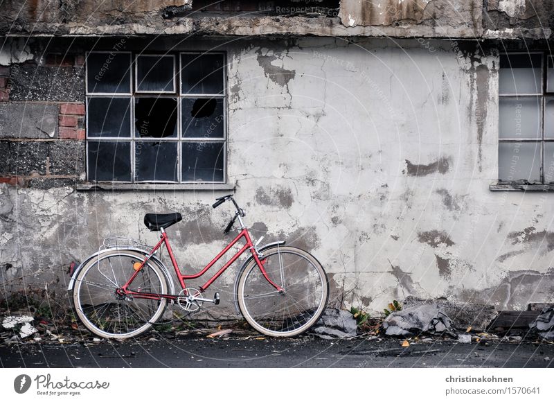 Red bike, grey wall. Trist and kaput. Bicycle Ladies' bicycle hollandrad Industrial plant Wall (barrier) Wall (building) Window Cycling Stone Concrete Glass