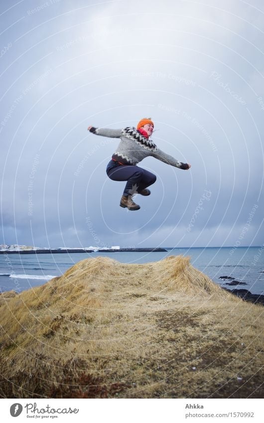 Jump from a cliff in wintry Iceland with view to the sea Life Well-being Contentment Trip Adventure Human being Young woman Youth (Young adults) 1 Landscape