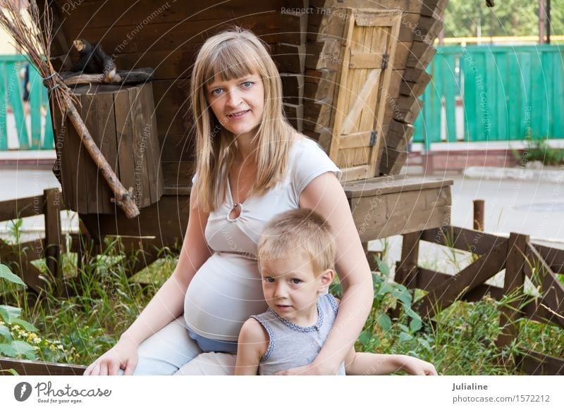 Pregnant mother and son on walk