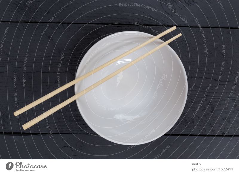 Bowl with sticks on black wood in bird's eye view Restaurant Gastronomy Old Black White shell Chopstick Anthracite Empty Wooden board Wooden table Wooden sign