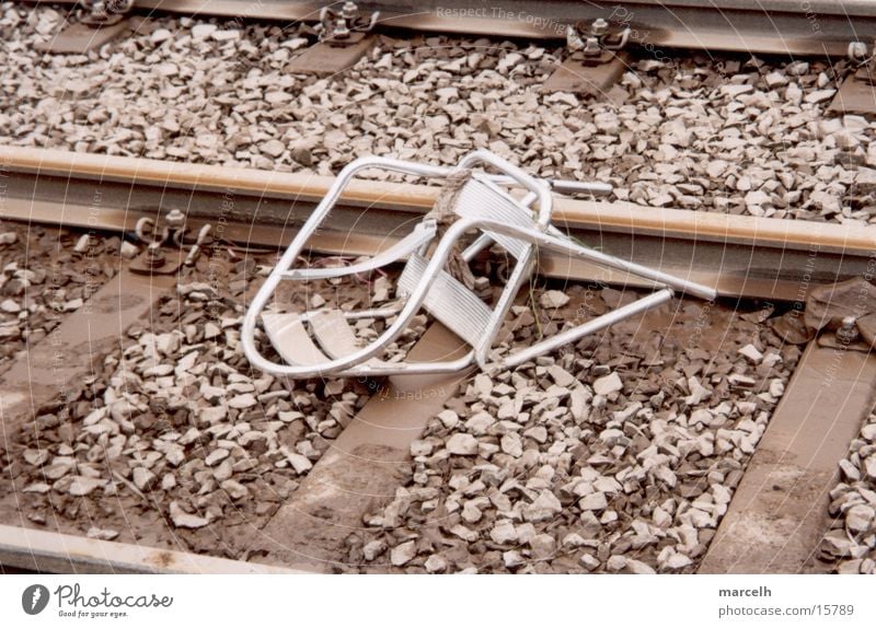 chair Railroad tracks Accident Sudden fall Tragedy Dangerous Fear Panic Chair capped Silver cafe chair