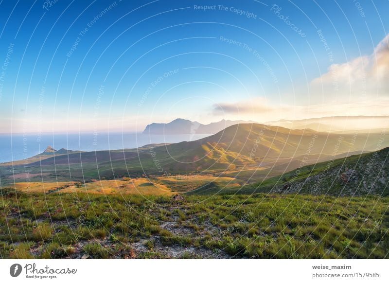 Spring sunset in the mountains. Seacoast and hills Beautiful Summer Ocean Mountain Nature Landscape Sky Clouds Sunrise Sunset Beautiful weather Grass Meadow