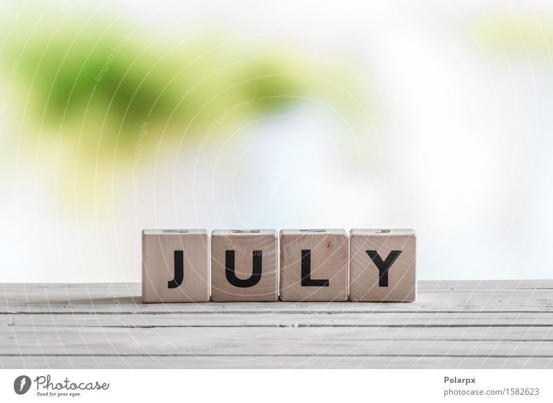 July sign on a wooden table Design Playing Reading Summer Infancy Group Wood Build Discover Uniqueness cube Symbols and metaphors Text Conceptual design Word