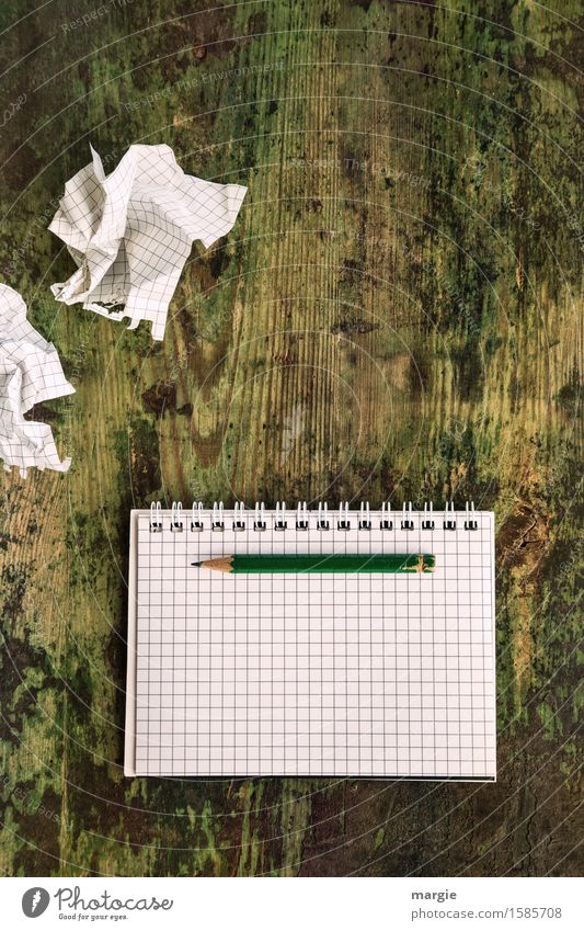 Unimaginative! Empty crumpled notepads with a blank notepad with checkered paper and a pencil on an old wooden table Work and employment Office work Workplace