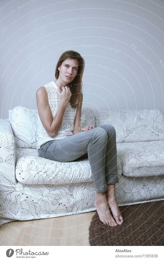 Learn more about it Elegant Sofa Room Young woman Youth (Young adults) Legs 18 - 30 years Adults Jeans Top Barefoot Brunette Long-haired Looking Sit Esthetic