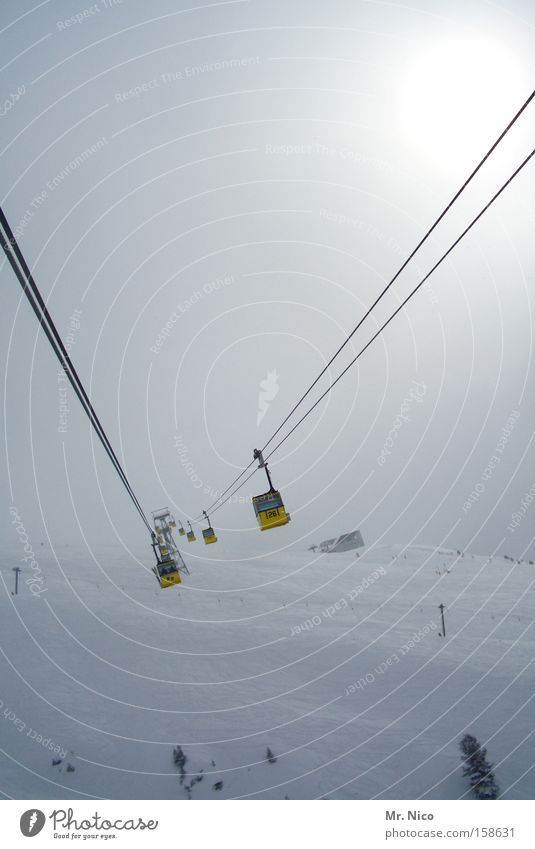Weightless Winter Cable car Yellow Hover Fog Mountain Means of transport Passenger traffic Ski resort Aviation Wire cable Snow Gondola Central perspective