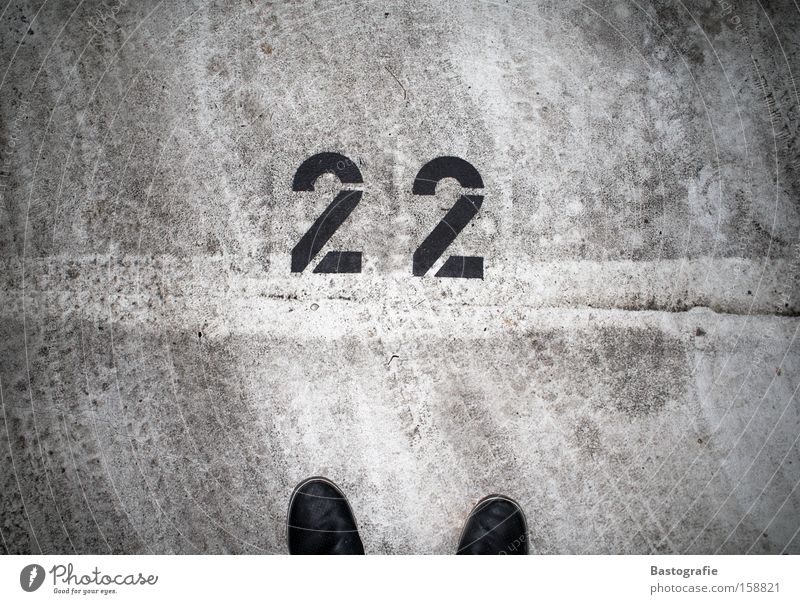 22 Digits and numbers Footwear Street Parking lot Motor vehicle Tracks Footprint Concrete Tar Transport Traffic infrastructure schnapps number Dirty