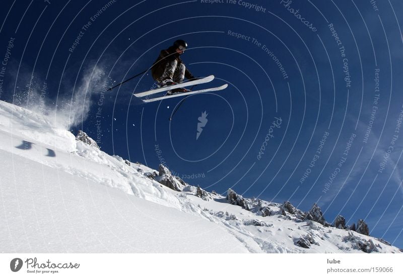 THE HIGH-FLYER Skiing Winter Deep snow Powder snow Long jump Skier Winter sports Winter's day Snowscape Flying Sports Playing Extreme sports freerider