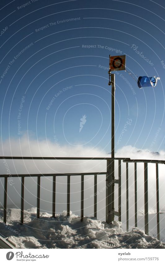 O in the wind Weather Sky Winter Clouds Mountain Barrier Peak Vantage point Far-off places Safety Vacation & Travel Platform Flag Tornado Wind Wind direction