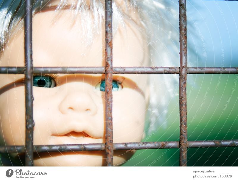 Behind bars Grating Iron Captured Loneliness Doll Toys Plastic Head Looking Longing Freedom Escape Eyes Penitentiary Fear Panic