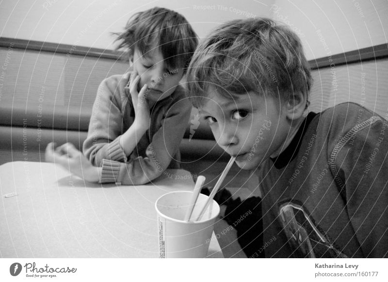 fast food Black & white photo Interior shot Central perspective Wide angle Looking into the camera Beverage Drinking Mug Straw Child Human being Boy (child)