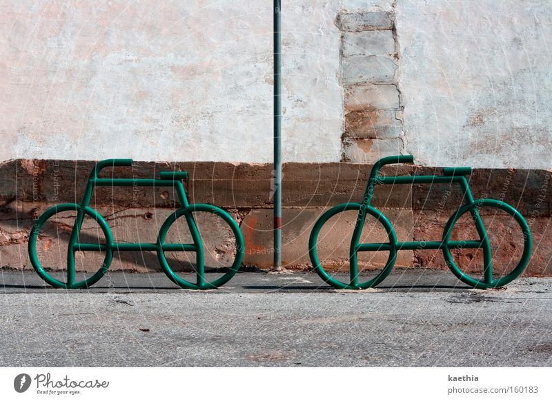 bike tour Bicycle Traffic infrastructure Street Signs and labeling Green Wheel Bicycle rack Structures and shapes Wall (building) Metal Wall (barrier)