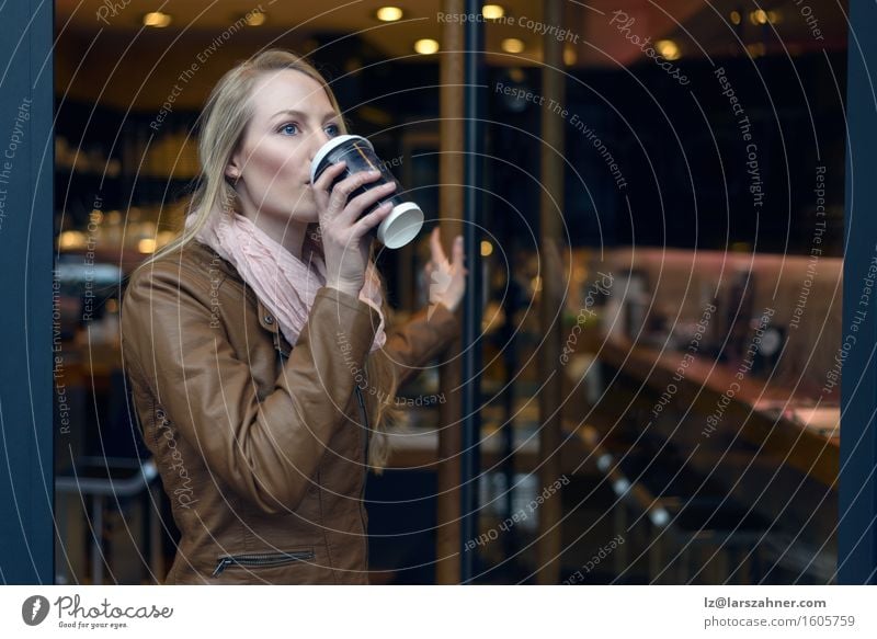 Blond woman sipping coffee from a cup while leaving a bistro Beverage Drinking Coffee Restaurant Feminine Woman Adults 1 Human being 18 - 30 years