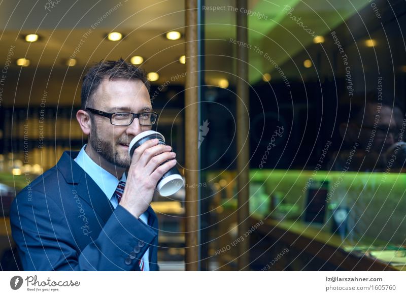 Middle-aged bearded man in blue business suit and necktie sipping coffee from cup near door of bistro Coffee Business Man Adults 1 Human being 30 - 45 years