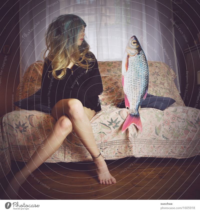 girl with wig on a sofa next to a fish  remixcase - date with fish - a Royalty  Free Stock Photo from Photocase