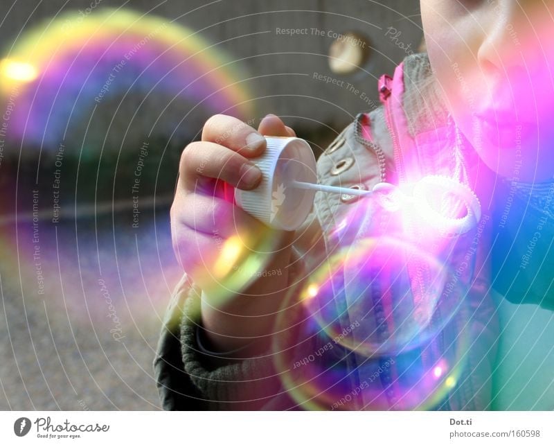 Child with colourful soap bubbles Colour photo Multicoloured Exterior shot Copy Space left Day Reflection Upper body Joy Playing Human being Toddler Girl