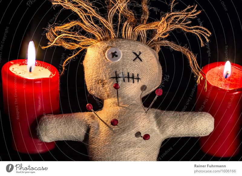 a Voodoo doll between two red candles (Stacking) Exotic Hallowe'en Art Work of art Subculture Shows Doll Kitsch Odds and ends Collector's item Emotions Belief