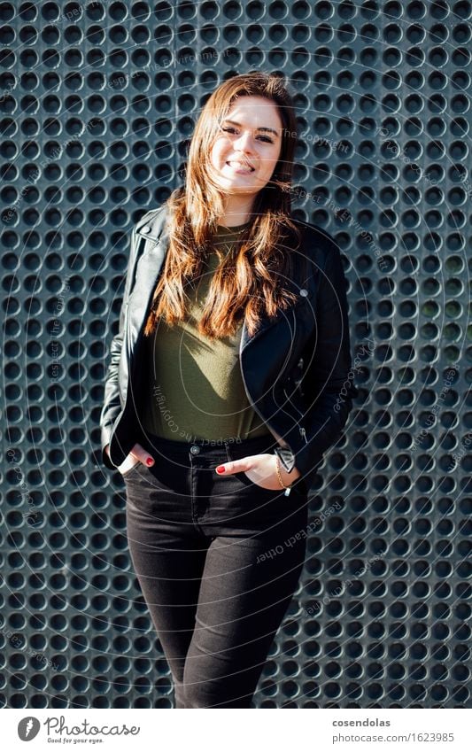 Young brunette woman in outdoor everyday clothes in front of a minimalist façade Lifestyle University & College student Feminine Young woman