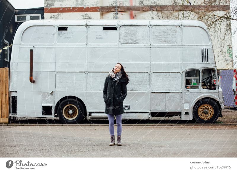 Young woman stands in front of a bus Feminine Youth (Young adults) Woman Adults 18 - 30 years Stand Cold Bus Old-school Retro Jacket Coat Brunette Winter