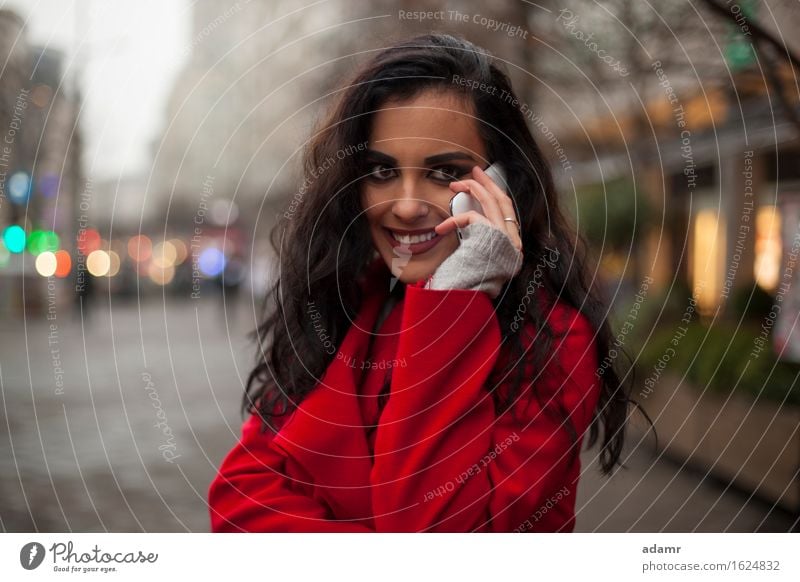 Woman in red coat with mobile phone in hands, smartphone, urban scene woman smile smiling lifestyle girl person cold winter female technology telephone cell