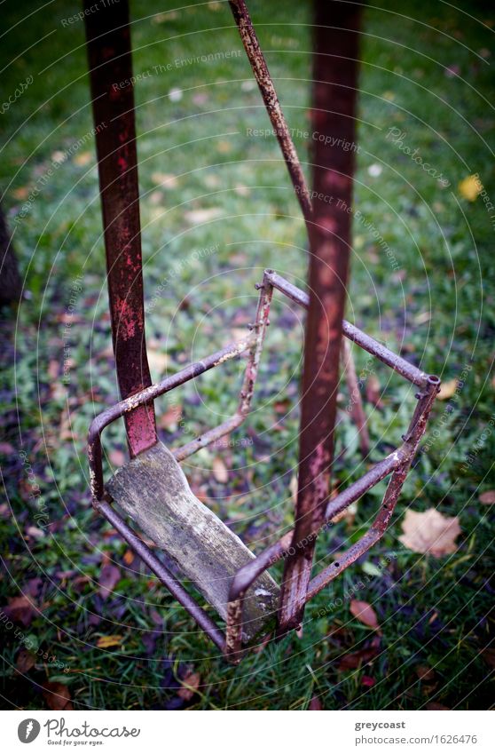 The broken child's swing. Unhappy childhood. Garden Infancy Autumn Park Forest Old Sadness Loneliness Seesaw teeter-totter vintage yard Backyard damage Vertical