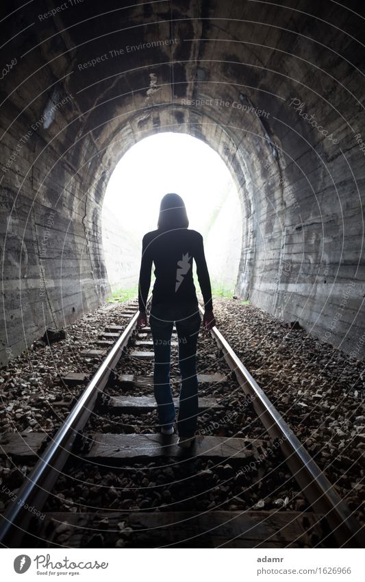 Women in a tunnel looking towards the light adventure afterlife arched architecture asylum bright dark daylight escape enlightenment faith future hope