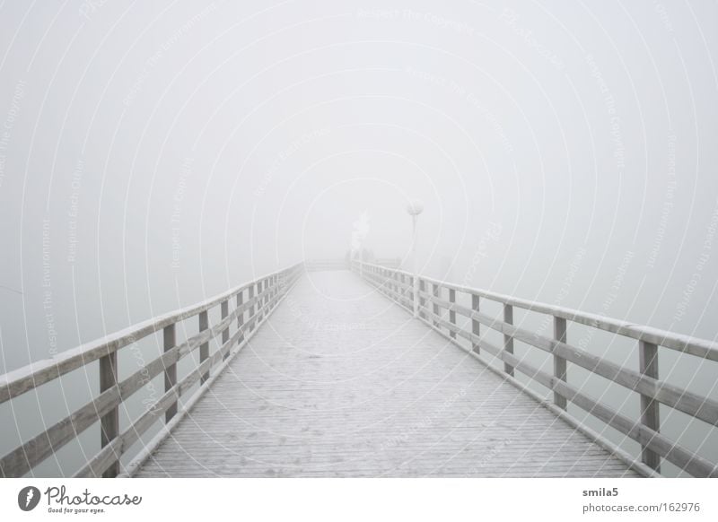 bridge in the fog Footbridge Fog Cold Water Ocean Coast Loneliness Calm Far-off places Hope Winter Ambiguous Meditative Future White Wood Transience