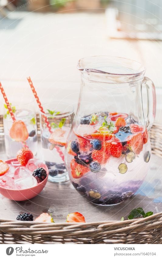 jug with water, berries and ice cubes on the garden table Food Fruit Beverage Cold drink Lemonade Juice Glass Style Design Healthy Eating Life Summer