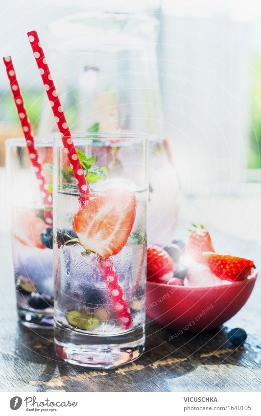 glasses with berries lemonade , red straw and ice cubes Food Fruit Beverage Cold drink Lemonade Juice Longdrink Cocktail Glass Straw Lifestyle Healthy Eating