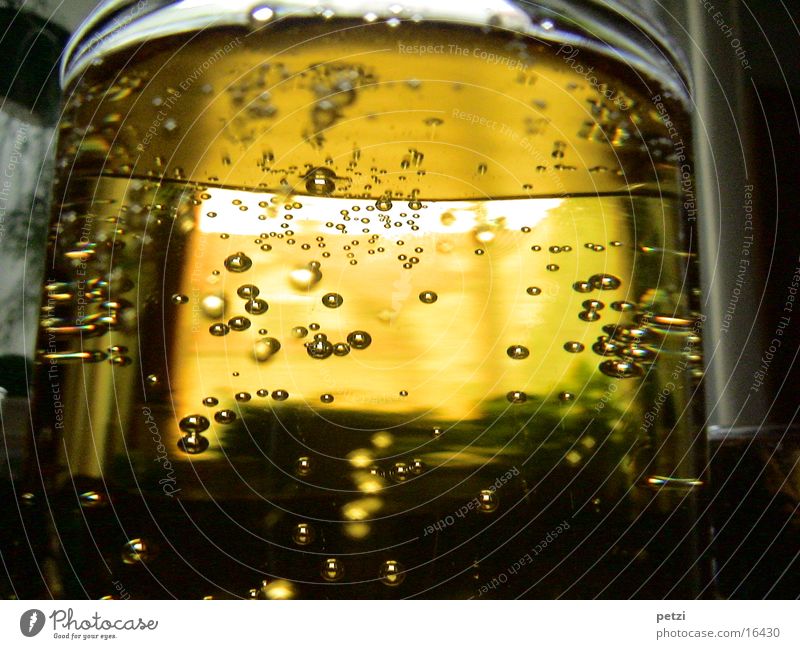 tingling Drinking Juice Alcoholic drinks Glass Fluid Yellow Thirst Syrup Air bubble Shaft of light Alcohol-fueled Colour photo Interior shot Detail