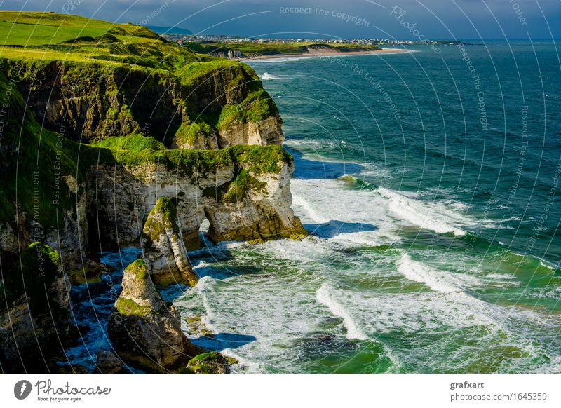Coast with cliffs at Portrush in Northern Ireland Cliff Atlantic Ocean Landscape Waves Vantage point Surf Rock Rocky coastline House (Residential Structure)
