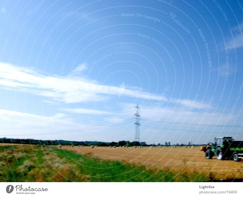 Tractor flag Blur Field Bale of straw Autumn Electricity pylon Wheat Wheatfield Combine Electrical equipment Technology Landscape Dynamics Sky power lines