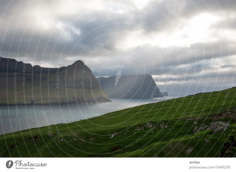 Landscape on the Faroe Islands as seen from Vidareidi Sun Ocean Mountain Hiking Grass Meadow Rock River Stone Green Emotions intense Dramatic mood positive