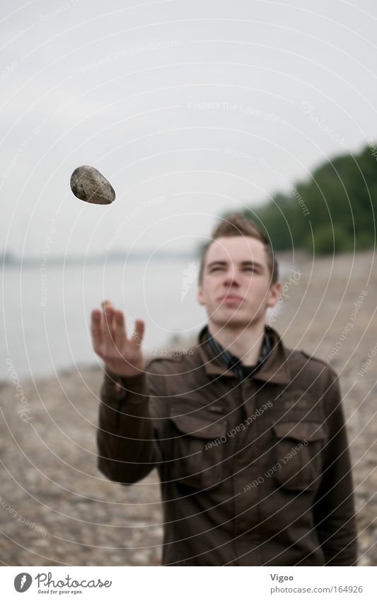 Flying stone Subdued colour Exterior shot Copy Space top Evening Blur Masculine Young man Youth (Young adults) 1 Human being 18 - 30 years Adults Water Jacket