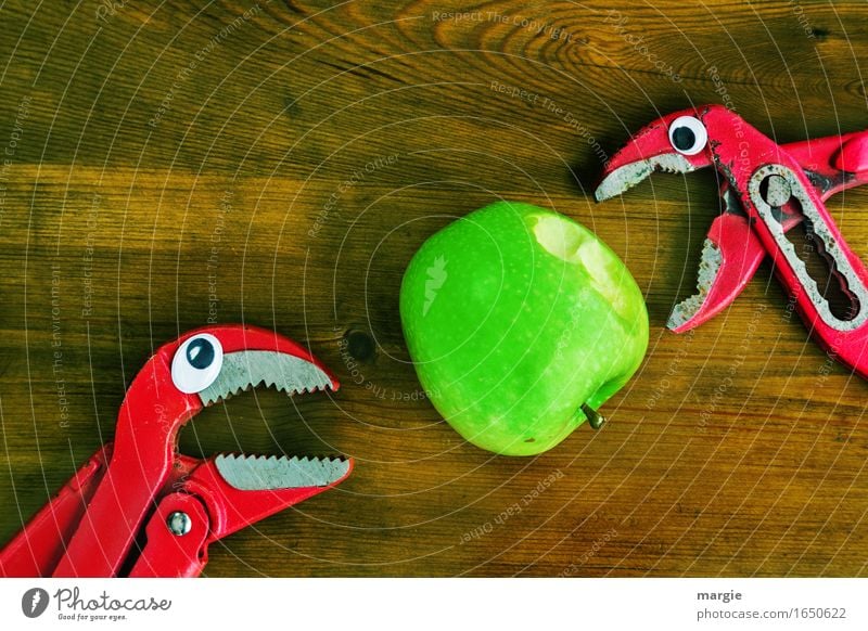 ...tastes good, take a bite! Two pincers with eyes biting into a green apple Food Fruit Apple Organic produce Diet Craftsperson Workplace Construction site