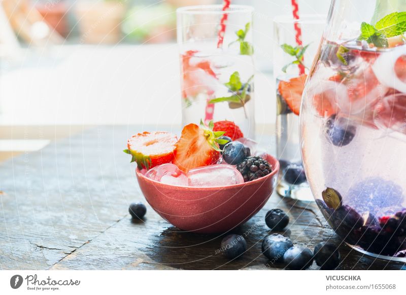Ice cubes and berries in bowl on the garden table Food Fruit Dessert Ice cream Beverage Cold drink Drinking water Lemonade Juice Bowl Glass Style Design