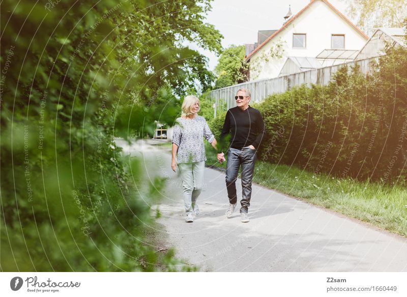 Retired couple out for a walk Leisure and hobbies Female senior Woman Male senior Man Couple Partner 60 years and older Senior citizen Landscape Summer
