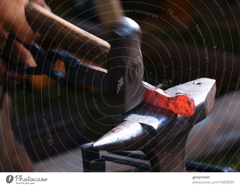 Traditional style blacksmith at work. Hammer hands and iron. Work and employment Industry Craft (trade) Tool Human being Hand 1 Art Metal Steel Old Dirty Dark