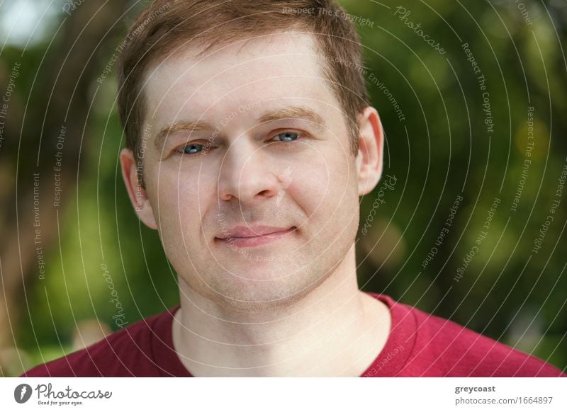 Middle-aged man looking to the camera in the park. Close up portrait. Lifestyle Happy Beautiful Face Business Man Adults 30 - 45 years Hair Smiling Friendliness