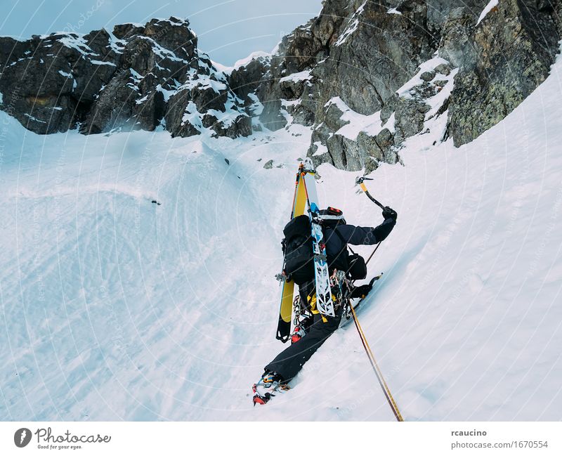 Ice climbing: mountaineer on a mixed route of snow and rock Vacation & Travel Adventure Expedition Winter Snow Mountain Sports Climbing Mountaineering Success