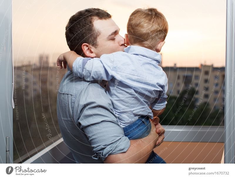 Thirty year old father kisses his three year old son on the balcony Lifestyle Joy Happy Face Vacation & Travel Sun Parenting Child Human being Boy (child)