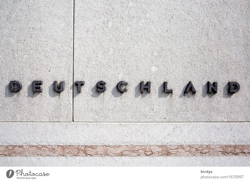 Germany. raised writing on a stone wall Characters Wall (barrier) Wall (building) Stone Metal Line Simple Positive Gray Black Self-confident Society Identity