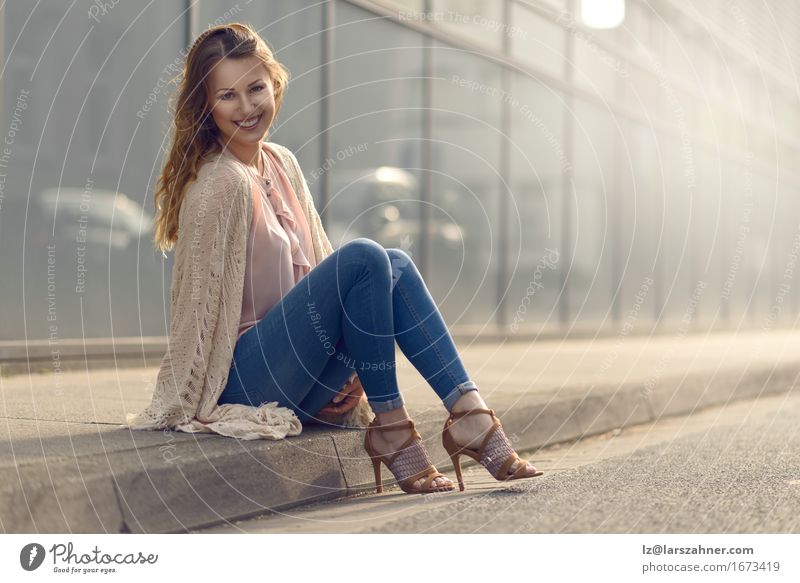 Smiling young woman relaxing on sidewalk Beautiful Face Feminine Woman Adults 1 Human being 18 - 30 years Youth (Young adults) Street Fashion High heels