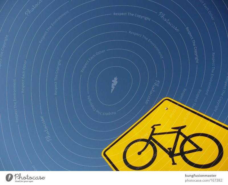 Bicycle path to heaven Colour photo Exterior shot Day Contrast Sunlight Cloudless sky Transport Road traffic Street Road sign Metal Sign Driving Blue Yellow