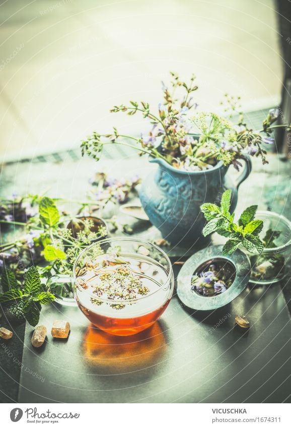 Cup with herbal tea on the terrace or garden table Food Herbs and spices Organic produce Vegetarian diet Diet Beverage Hot drink Tea Bottle Glass Lifestyle