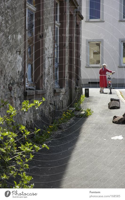 Walk across the street in red Colour photo Multicoloured Exterior shot Day Contrast Sunlight Sunbeam Rear view Looking back Infancy Summer Village Old town